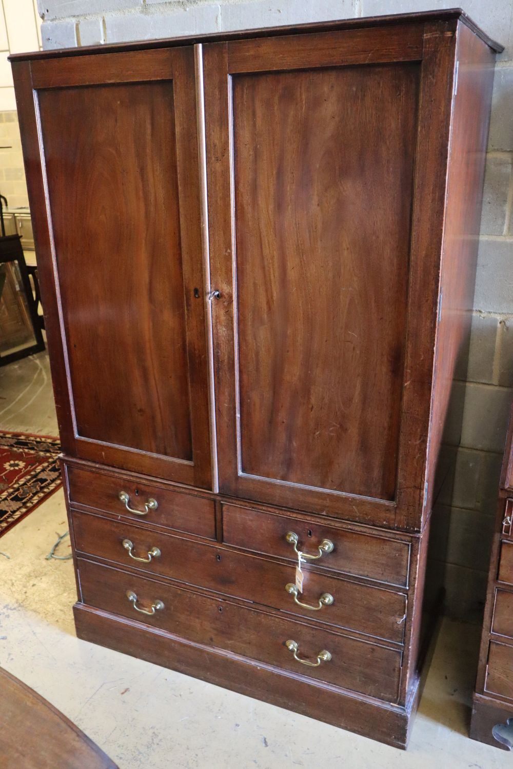 An early 19th century mahogany linen press, width 117cm height 187cm